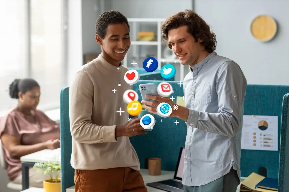 featuring two best performance marketing specialist in dubai professionals interacting with a phone surrounded by floating social media icons.